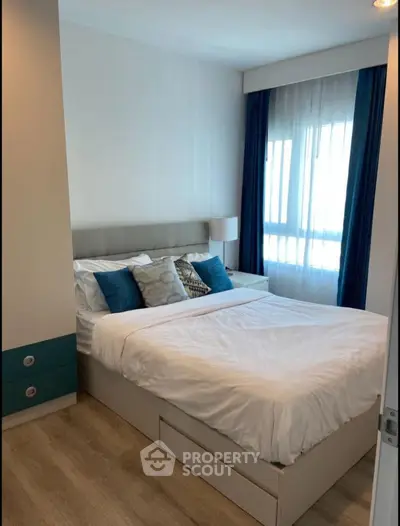 Cozy bedroom with modern decor and natural light, featuring a comfortable bed and stylish curtains.