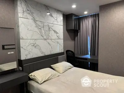 Modern bedroom with marble accent wall and study desk