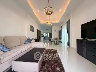 Spacious modern living room with elegant lighting and open layout, perfect for relaxation and entertainment.