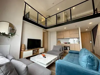 Modern loft-style living room with high ceiling and stylish furniture