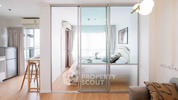 Modern apartment with open layout, featuring a cozy bedroom and stylish kitchen.