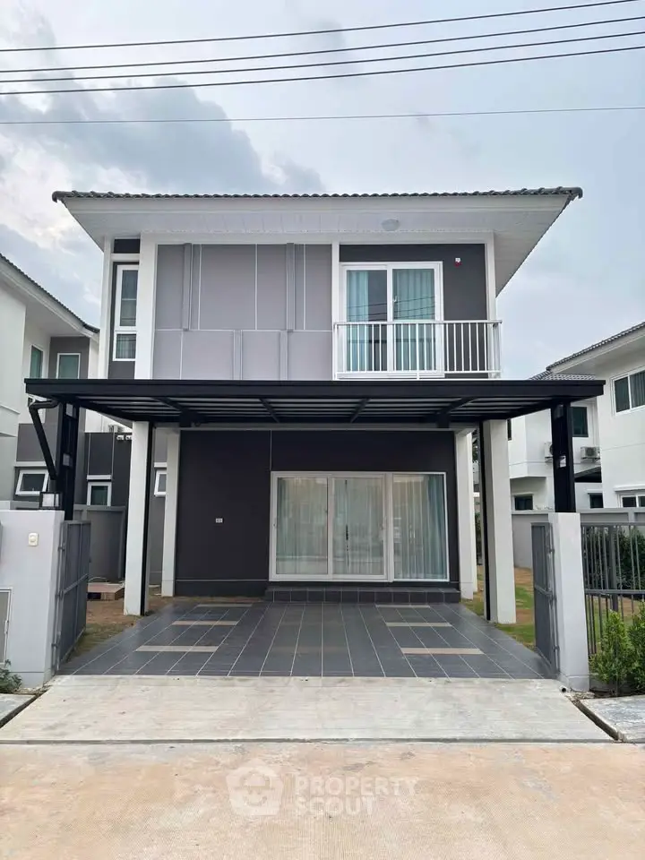 Modern two-story house with sleek design and spacious driveway in a serene neighborhood.