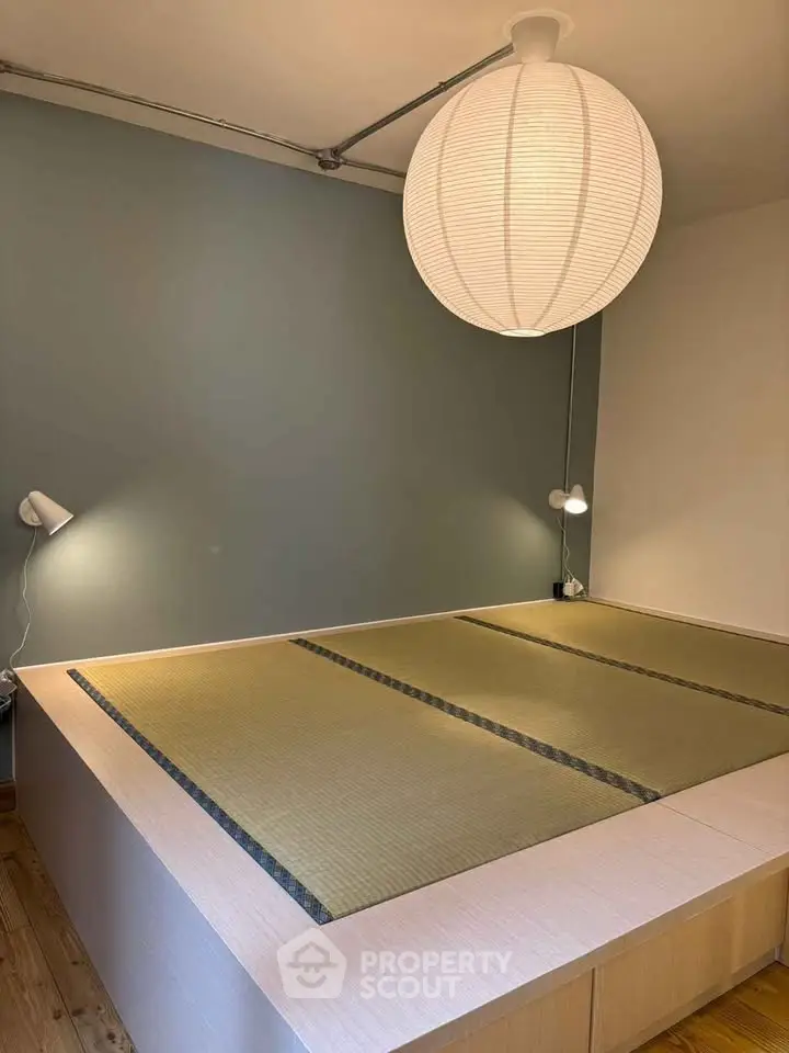 Minimalist bedroom with tatami mat flooring and modern lighting