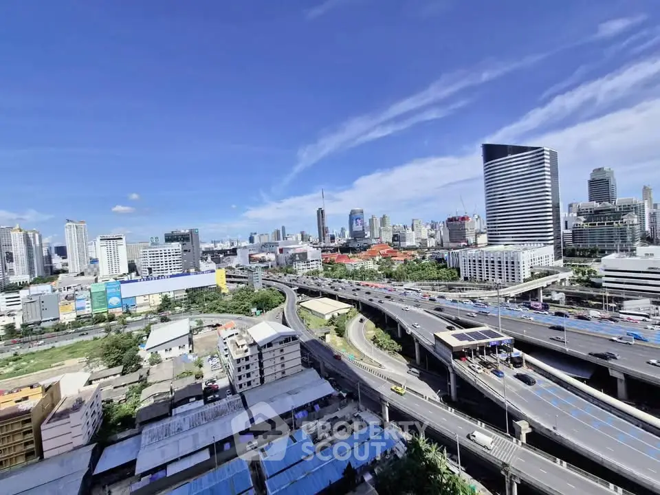 Stunning cityscape view showcasing modern skyscrapers and bustling highways under a clear blue sky.