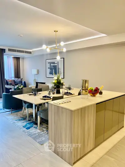 Luxurious open-plan living and dining area with modern kitchen island and elegant decor.