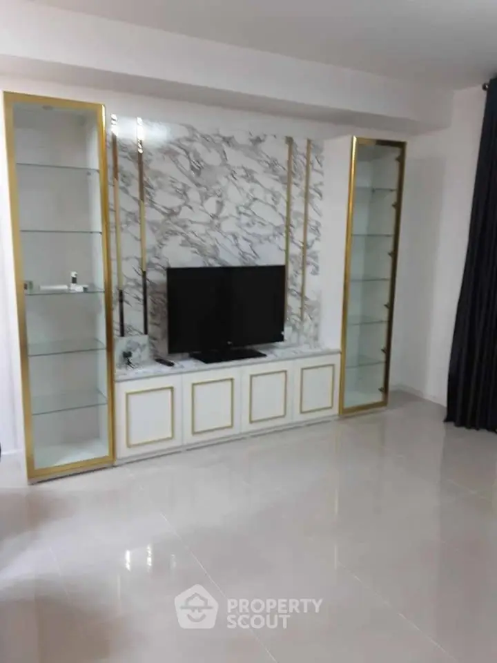 Elegant living room with marble accent wall and built-in TV unit