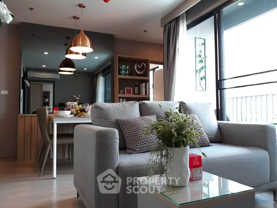 Modern living room with stylish decor and large windows offering natural light.