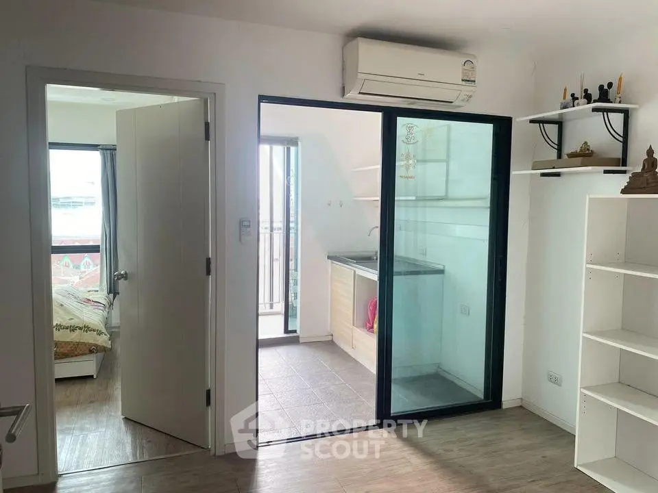 Modern apartment interior with bedroom, balcony, and air conditioning