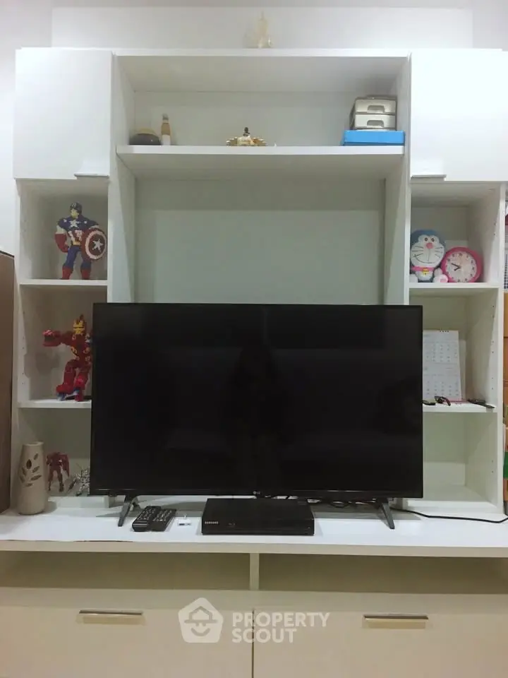 Modern living room with sleek TV unit and decorative shelves