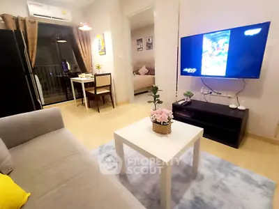 Modern living room with cozy decor, open layout, and a glimpse of the bedroom, perfect for urban living.