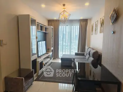 Modern living room with stylish decor and large window offering city views