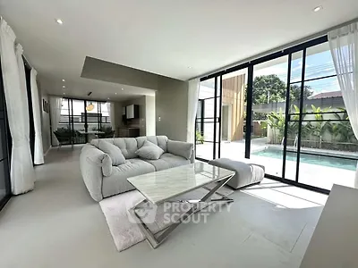Luxurious living room with pool view and modern furniture