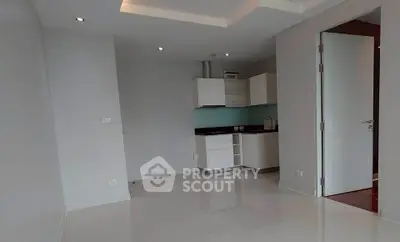Modern minimalist kitchen with sleek cabinetry and open layout in a bright apartment.