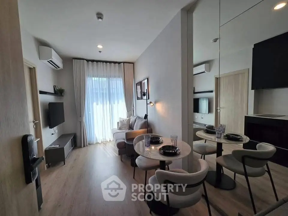 Modern living room with dining area, stylish decor, and natural light