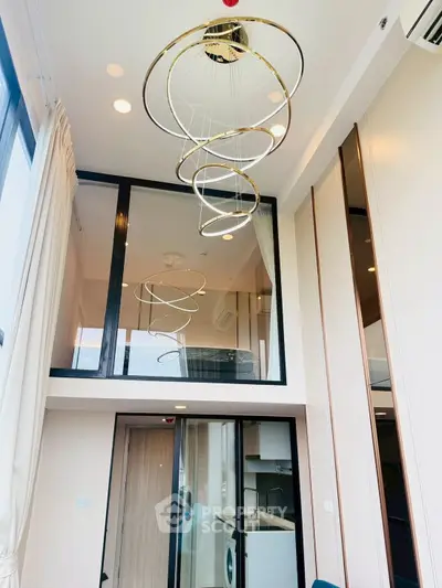 Modern duplex apartment with high ceilings and stylish spiral chandelier