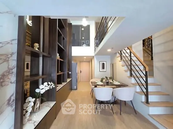 Modern duplex interior with elegant dining area and stylish staircase