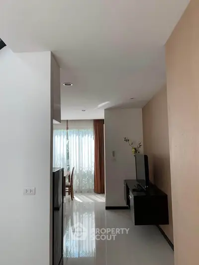 Modern living room with sleek TV stand and natural light