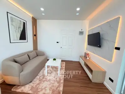 Modern living room with stylish decor and wall-mounted TV