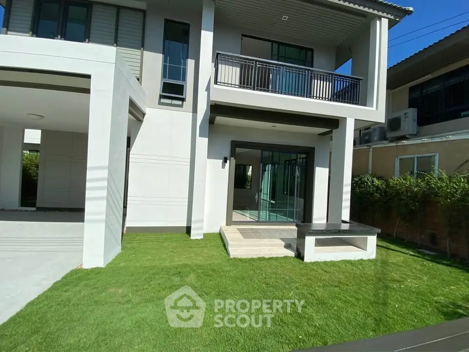 Modern two-story house with spacious lawn and balcony
