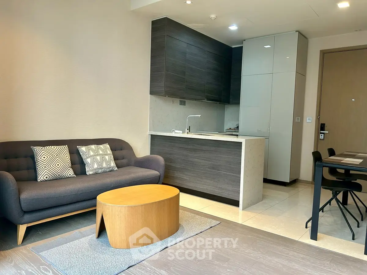 Modern open-plan living room with sleek kitchen and stylish furniture