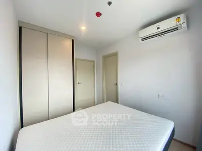 Modern minimalist bedroom with air conditioning and built-in wardrobe