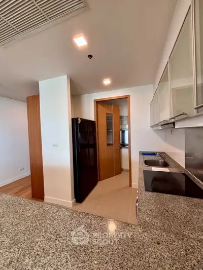 Modern kitchen with sleek countertops and built-in appliances in a stylish apartment.