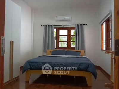 Cozy bedroom with modern decor and natural light, featuring a comfortable bed and stylish curtains.