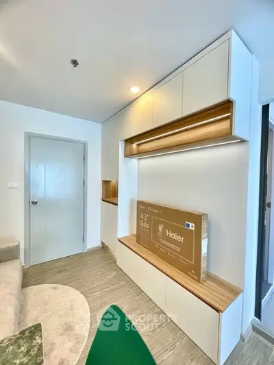 Modern living room with built-in storage and Haier TV box, showcasing sleek design and functionality.