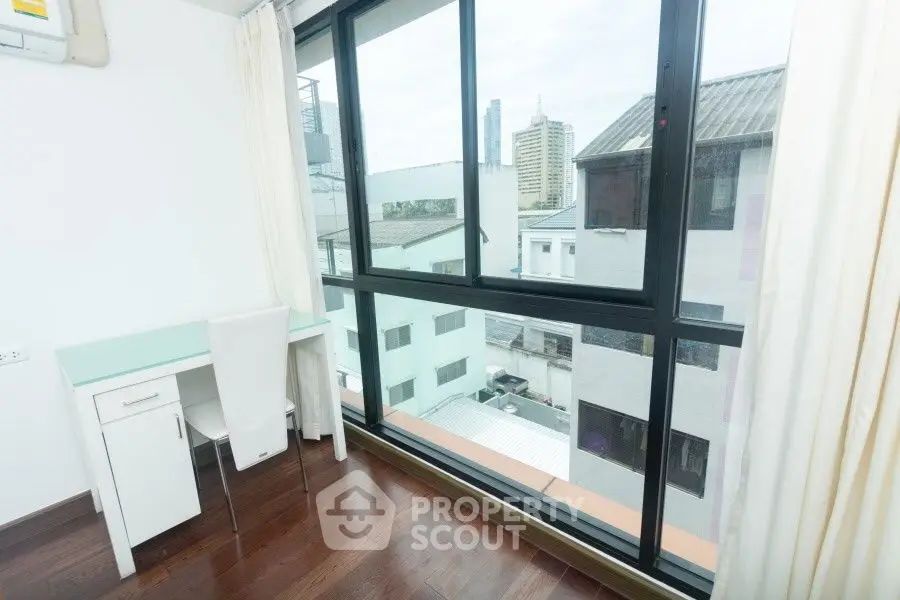 Bright study room with city view and large window in modern apartment