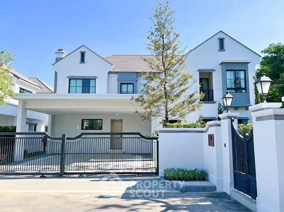 Elegant two-story house with modern design and spacious driveway in a serene neighborhood.