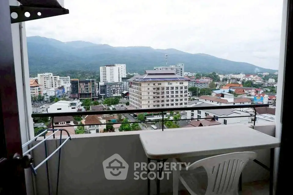 Stunning balcony view overlooking cityscape and mountains, perfect for relaxation and enjoying the scenery.