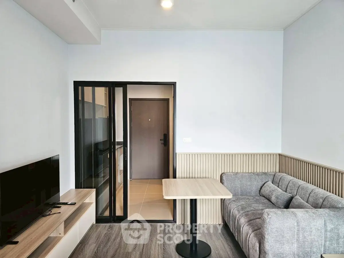 Modern living room with sleek furniture and sliding glass door