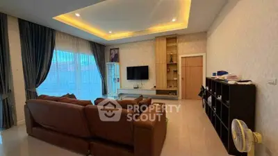 Spacious living room with modern decor and large windows for natural light.