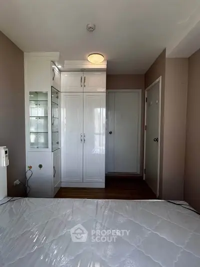 Cozy bedroom with built-in wardrobe and natural light