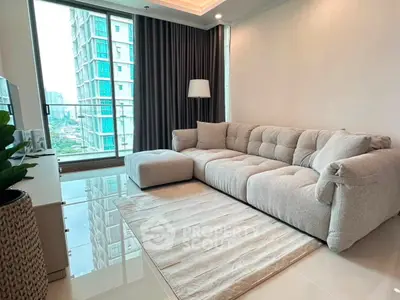 Modern living room with plush sofa and city view, featuring sleek design and natural light.