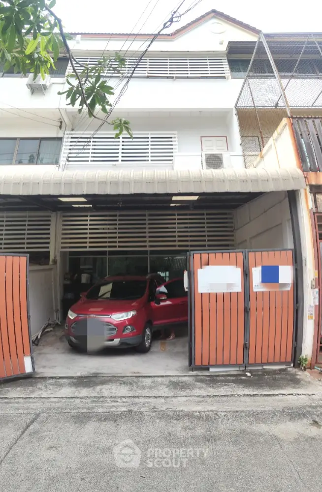 Spacious townhouse with secure garage and modern facade in urban setting