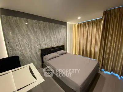 Modern bedroom with stylish decor and ample natural light