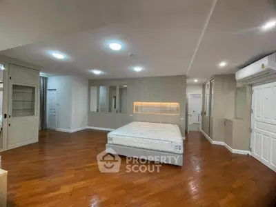 Spacious bedroom with modern design and wooden flooring