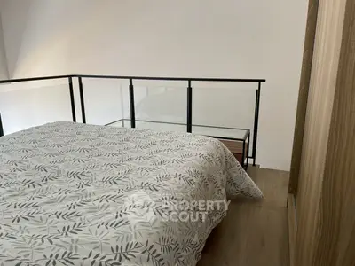 Modern bedroom with stylish railing and cozy bedding in a contemporary home.