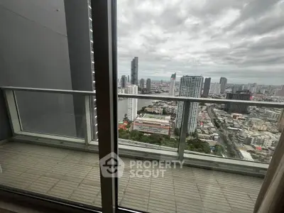Stunning cityscape view from high-rise balcony with glass railing and tiled floor.