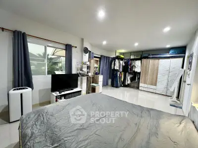 Spacious bedroom with modern decor and ample storage space