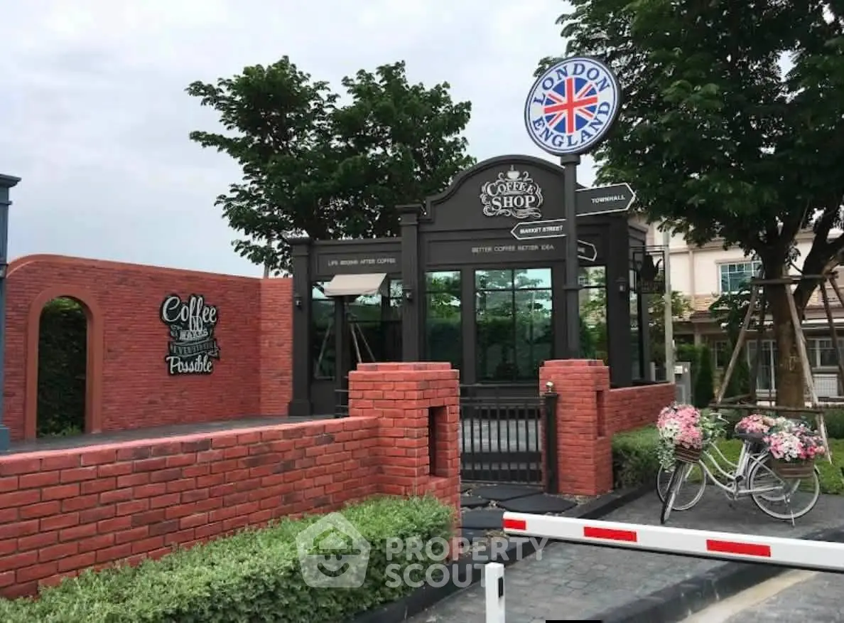 Charming coffee shop exterior with brick facade and lush greenery, perfect for a cozy neighborhood vibe.