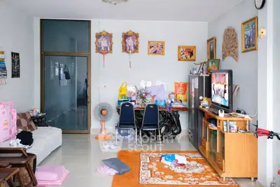 Cozy living room with eclectic decor and entertainment center, perfect for family gatherings.
