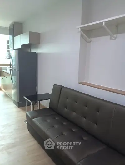 Modern studio apartment with sleek kitchen and cozy living area, perfect for urban living.