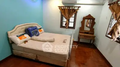 Cozy bedroom with wooden flooring and elegant vanity set