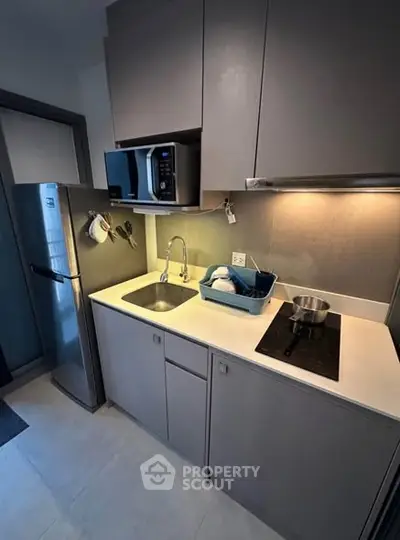 Modern compact kitchen with sleek appliances and efficient layout