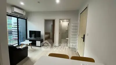 Modern apartment interior with open living space and balcony view.