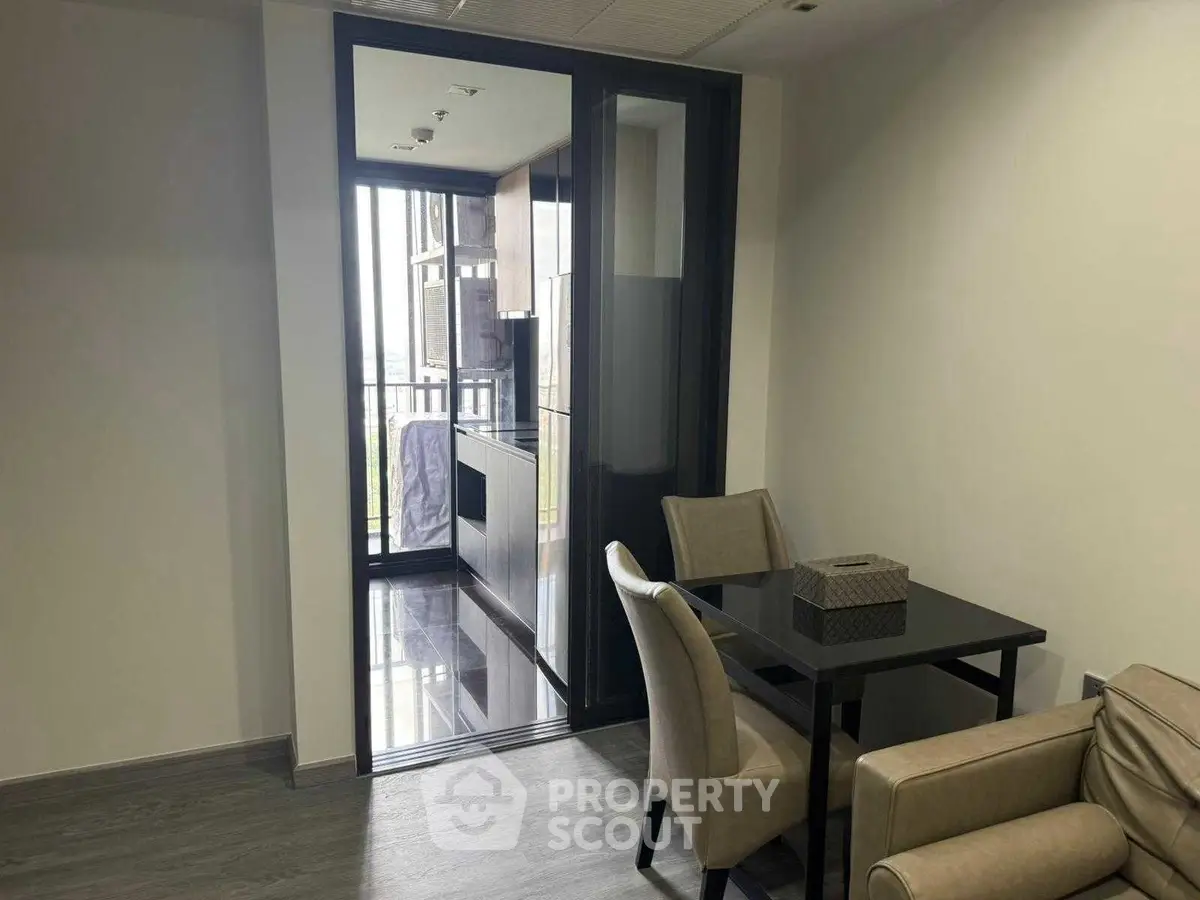 Modern dining area with sleek furniture and balcony view