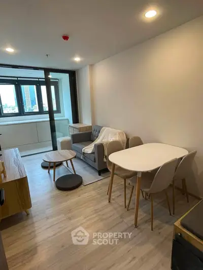 Modern living room with cozy furniture and city view, perfect for urban living.