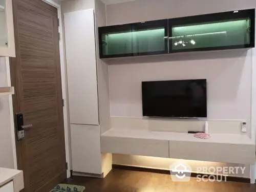 Modern living room with wall-mounted TV and stylish storage units